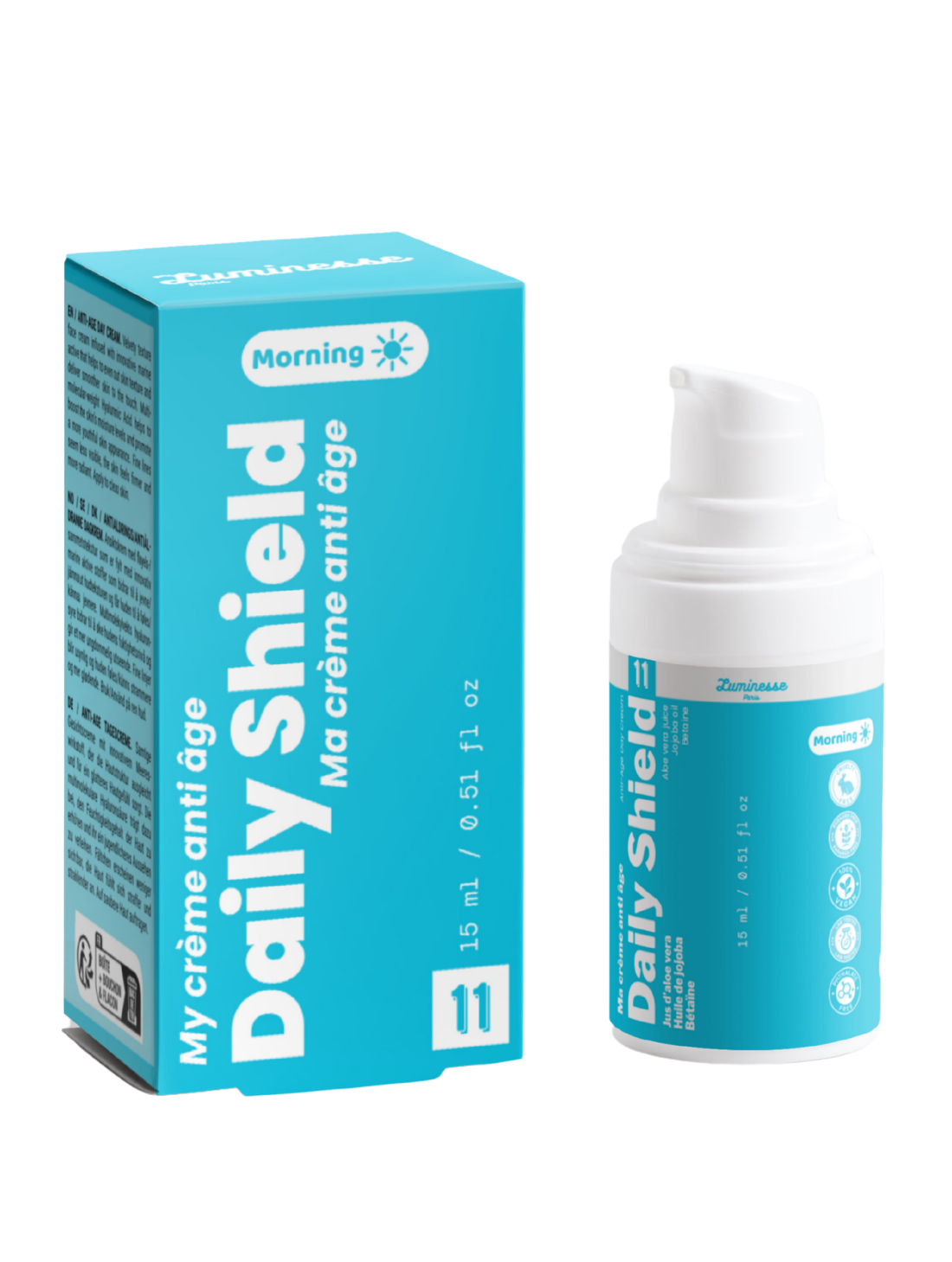 Packshot de Daily Shield n°11 de Luminesse Paris avec son étui turquoise et son flacon pompe blanc de 15 ml. La boîte et le flacon sont présentés côte à côte sur fond transparent ; le packaging indique une crème anti-âge pour le matin et mentionne notamment jus d’aloe vera, huile de jojoba et bétaïne.