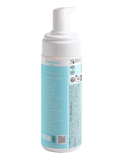 Vue arrière de Silk Cleanse n°02 de Luminesse Paris, mousse nettoyante visage en flacon pompe blanc avec étiquette turquoise. Le dos du packaging affiche la liste INCI, avec notamment eau de rose, calendula et camomille, ainsi qu’un QR code, la certification B Corporation et les informations de recyclage.